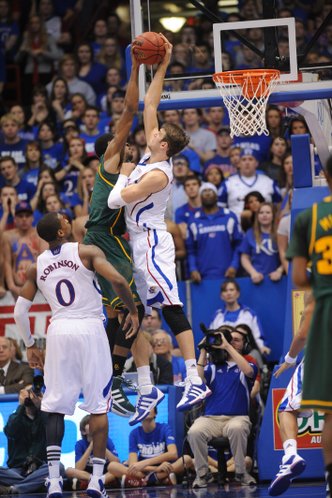 Jeff Withey gets a hand on a shot by Baylor forward Perry Jones.