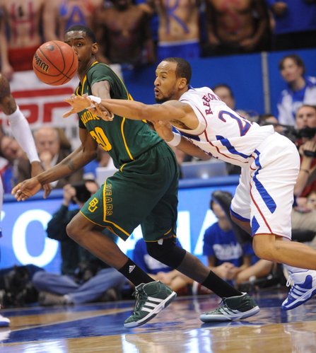 Kansas junior Travis Releford reaches for a loose ball against Baylor's Quincy Miller in the second half on Monday January 16, 2012 in Allen Fieldhouse.