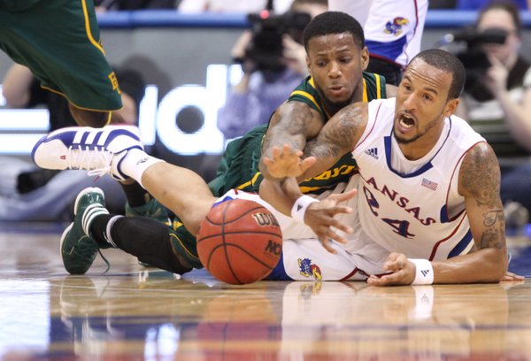 Kansas guard Travis Releford wrestles on the floor for a loose ball with Baylor guard Pierre Jackson during the first half on Monday, Jan. 16, 2012 at Allen Fieldhouse.