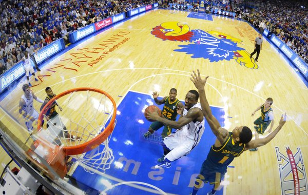 Kansas guard Tyshawn Taylor dips under Baylor forward Perry Jones for a bucket during the second half on Monday, Jan. 16, 2012 at Allen Fieldhouse.
