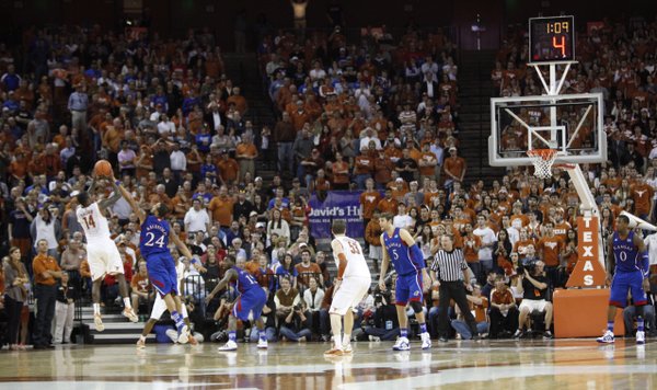 Kansas guard Travis Releford gets a hand on a three to block a shot by Texas guard J'Covan Brown late in the second half on Saturday, Jan. 21, 2012 at the Frank Erwin Center.