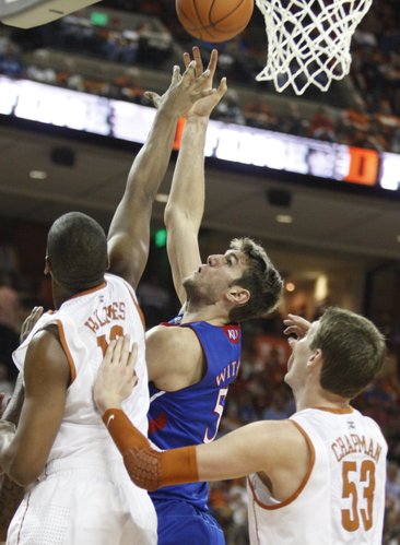 Kansas center Jeff Withey puts a shot over Texas defenders Jonathan Holmes (10) and Clint Chapman (53) during the second half on Saturday, Jan. 21, 2012 at the Frank Erwin Center.