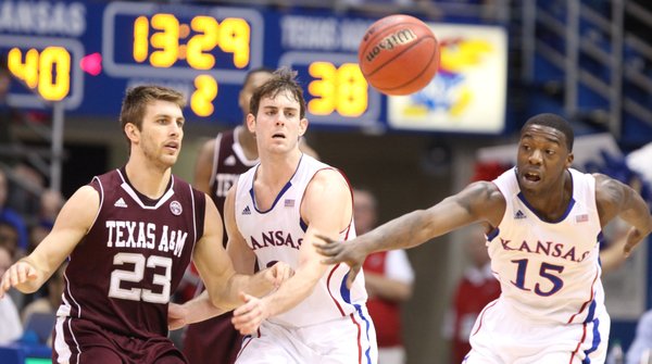 Kansas defenders Conner Teahan, center, and Elijah Johnson defend against a pass from Texas A&M guard Zach Kinsley during the second half on Monday, Jan. 23, 2012 at Allen Fieldhouse.