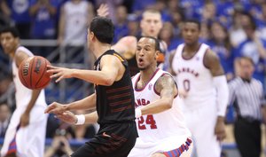 Kansas guard Travis Releford defends against Oklahoma State guard Cezar Guerrero during the first half on Saturday, Feb. 11, 2012 at Allen Fieldhouse.