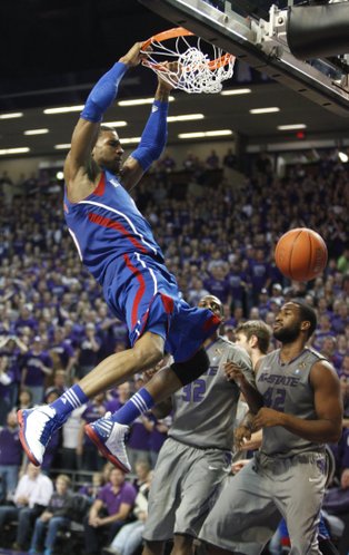 Kansas forward Thomas Robinson delivers a dunk before Kansas State players Thomas Gipson (42) and Jamar Samuels (32) during the second half on Monday, Feb. 13, 2012 at Bramlage Coliseum.