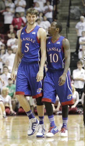 Jeff Withey (5) gets hug from Tyshawn Taylor (10) after a rebound and drawing a foul, in the last minute of the Jayhawks 66-58 win over the Aggies of Texas A&M.