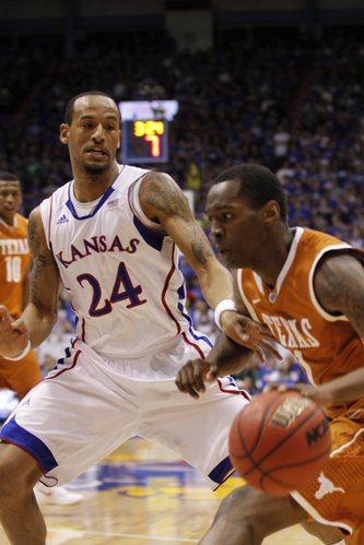 Kansas' Travis Releford (24) applies defensive pressure to Texas' Sheldon McCellan (1) during the first half Saturday, March 3, 2012 at Allen Fieldhouse.