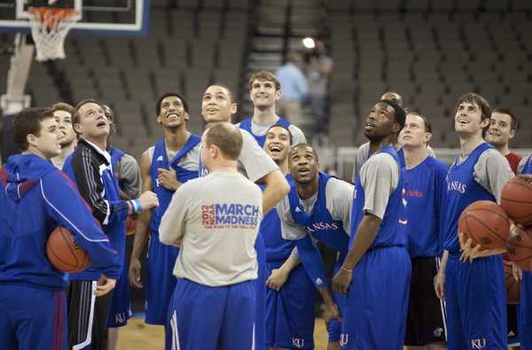 The Jayhawks and head coach Bill Self look up with anticipation as they follow a half-court shot from a player at the end of practice on Thursday, March 15, 2012 at Century Link Center in Omaha.