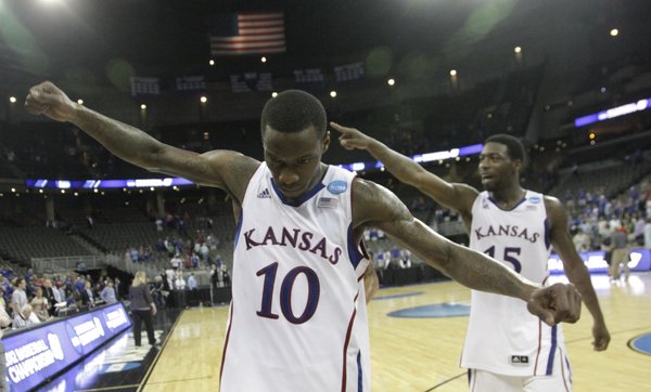 Tyshawn Taylor (10) and Elijah Johnson (15) walk off the court and acknowledge the crowd after KUÕs 63-60 win over the Purdue Boilermakers. KU will advance to the Sweet Sixteen game against North Carolina State, Friday, March 23, in St. Louis.