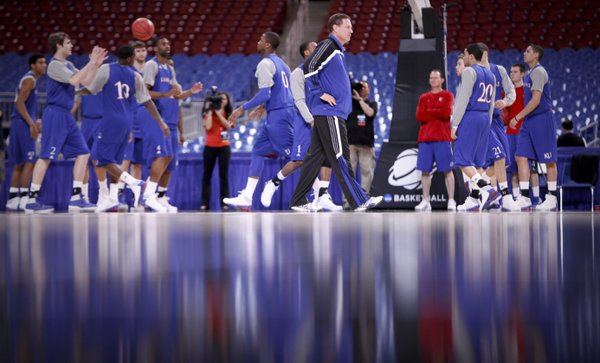 Kansas head coach Bill Self paces the court as the Jayhawks warm up with passing drills during the beginning of practice the Edward Jones Dome in St. Louis.