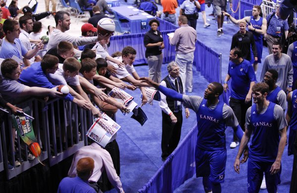 Kansas player Thomas Robinson reaches to slap hands with fans wanting autographs as the Jayhawks' are ushered off the court at the Edward Jones Dome in St. Louis.