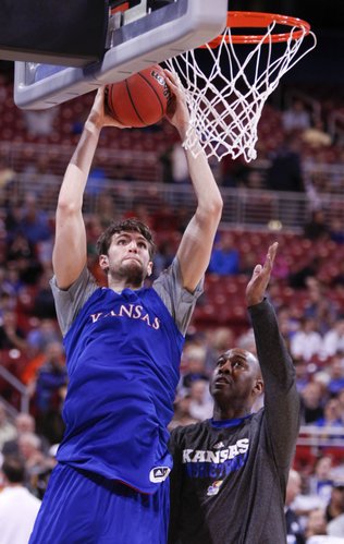 Kansas center Jeff Withey elevates for a dunk during drills with assistant coach Danny Manning at the Edward Jones Dome in St. Louis.
