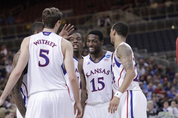 Elijah Johnson (15) along with from left, Jeff Withey, Tyshawn Taylor, and Travis Releford, laugh during a huddle in the second-half of the Jayhawks 60-57 win over North Carolina State in St. Louis Friday, March 16, 2012...