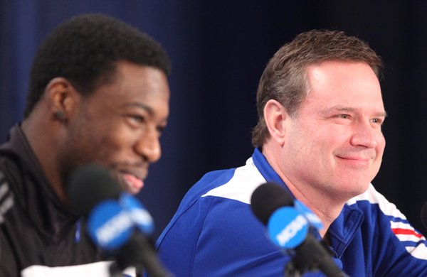 Kansas head coach Bill Self smiles next to Elijah Johnson as his players speak to his personality during a press conference on Saturday, March 24, 2012 at the Edward Jones Dome in St. Louis.