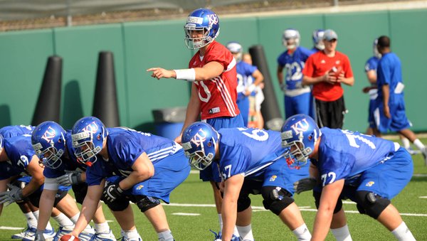 Kansas quarterback Dayne Crist (10) gets set to run a play during the first day of spring practices on Tuesday, March 27, 2012.