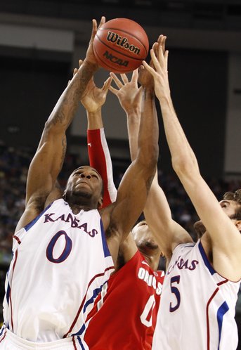 Kansas big men Thomas Robinson (0) and Jeff Withey (5) grab a rebound from Ohio State forward Jared Sullinger during the second half on Saturday, March 31, 2012 at the Superdome.