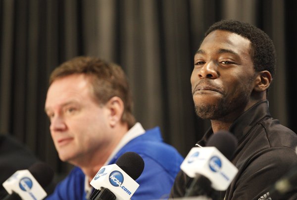 Kansas guard Elijah Johnson smiles as the team and head coach Bill Self sit during a press conference on Sunday, April 1, 2012 at the Superdome.