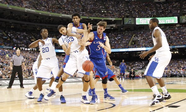 Kansas players Jeff Withey (5) and Kevin Young wrestle for a loose ball with Kentucky players Doron Lamb (20) Anthony Davis (23) and Darius Miller during the first half of the national championship on Monday, April 2, 2012 in New Orleans.