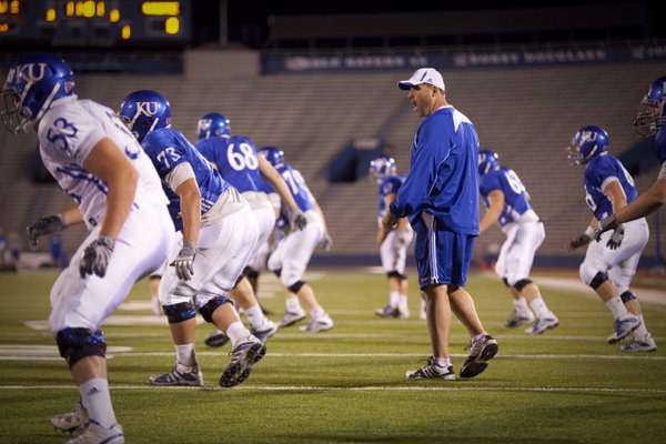 Offensive line coach Tim Grunhard works with his players during a morning practice on Thursday, April 19, 2012 at Memorial Stadium.