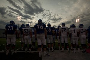 The morning sky brightens over Memorial Stadium as the Jayhawks watch over special teams practice on Thursday, April 19, 2012 at Memorial Stadium. 