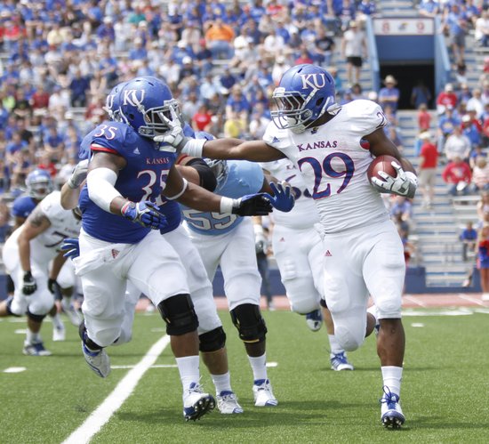 Kansas running back James Sims tries to stiff arm defensive end Toben Opurum during the second half of the Spring Game on Saturday, April 28, 2012 at Kivisto Field.