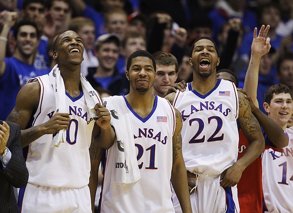 Former Kansas University players Thomas Robinson (0), Markieff Morris (21) and Marcus Morris (22) watch the action during a game against California in this file photo from Dec. 22, 2009 in Allen Fieldhouse.