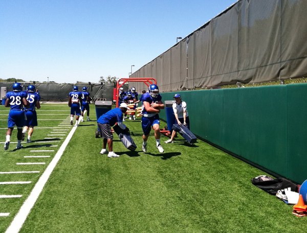 KU's running backs run the gauntlet during the opening portion of Sunday's practice.