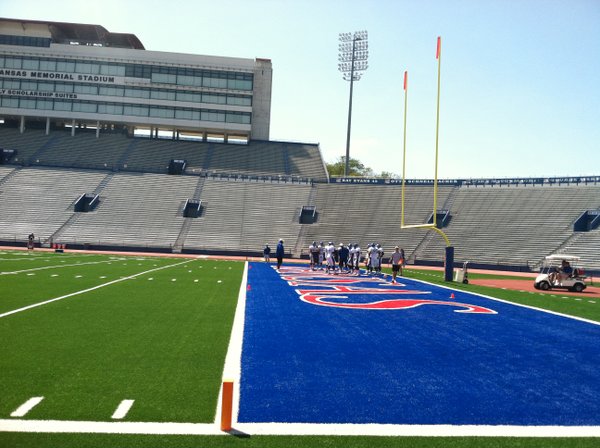 KU's defensive line works in the north end zone on the far side of the field during Friday's practice. 