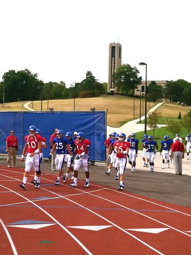 KU quarterback Dayne Crist (10) leads his group onto the field during Saturday morning's walk-through. 