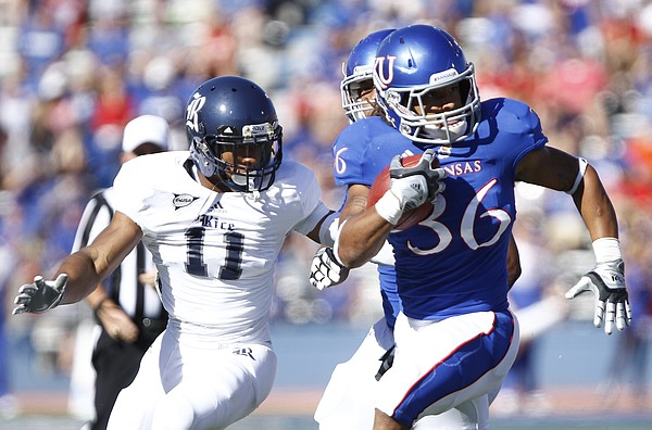 Kansas running back Taylor Cox is tailed by Rice cornerback Malcolm Hill during the third quarter on Saturday, Sept. 8, 2012 at Memorial Stadium.