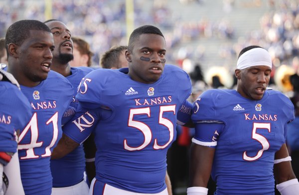 Kansas players Jimmay Mundine (41) Michael Reynolds (55) and Greg Brown (5) sing the Alma Mater to the student section following their 25-24 loss to Rice on Saturday, Sept. 8, 2012 at Memorial Stadium.