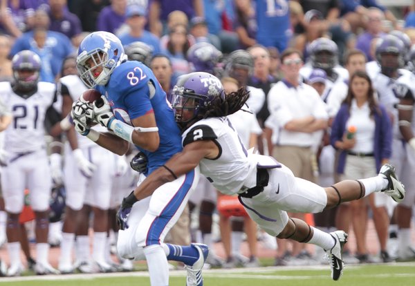 Kansas receiver Andrew Turzilli pulls in a deep pass as TCU cornerback Jason Verrett dives in for the tackle during the third quarter, Saturday, Sept. 15, 2012 at Memorial Stadium.