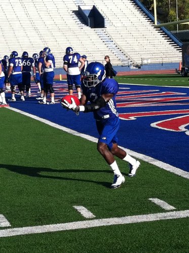 KU running back went through Wednesday's practice with a bulky brace on his left elbow. 