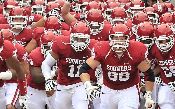 Oklahoma players take the field before their game Saturday against Texas in Dallas. The Sooners will entertain Kansas on Saturday.