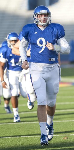 Kansas University quarterback Jake Heaps (9) warms up during practice on Tuesday, Oct. 23, 2012, at Memorial Stadium.