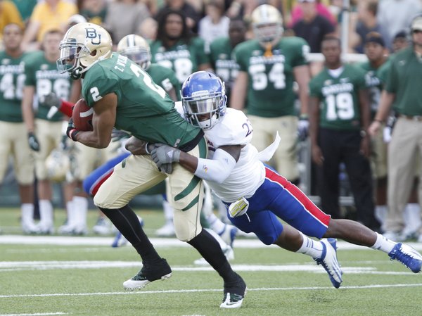 Kansas safety Dexter Linton drags down Baylor receiver Terrance Williams during the first quarter, Saturday, Nov. 3, 2012 at Floyd Casey Stadium in Waco, Texas.