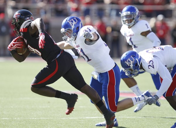 Kansas linebacker Ben Heeney chases down Texas Tech receiver Eric Ward after a catch during the first quarter on Saturday, Nov. 10, 2012 at Jones AT&T Stadium in Lubbock, Texas.