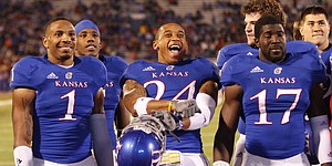 Kansas safety Bradley McDougald (24) reacts to seeing himself on a pregame highlight reel as he watches with the other seniors on Saturday, Nov. 17, 2012 at Memorial Stadium.