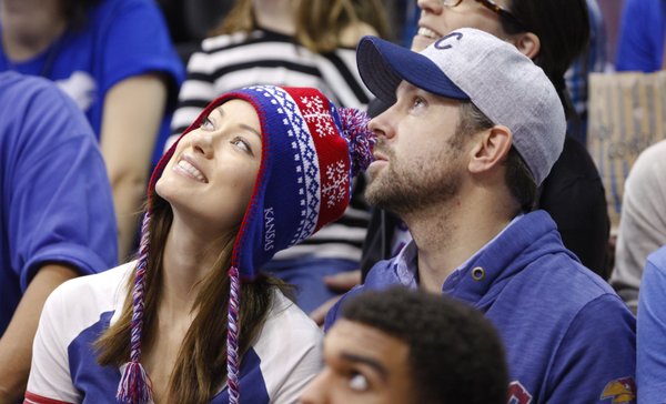 Actor Jason Sudeikis and actress Olivia Wilde watch the video board during the second half on Saturday, Dec. 29, 2012 at Allen Fieldhouse.