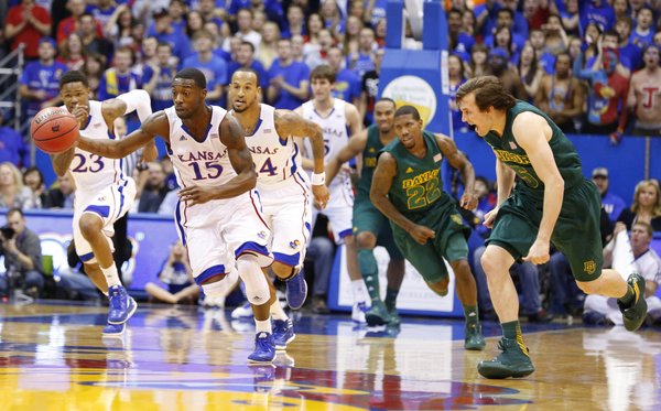 Kansas guard Elijah Johnson takes off up the court past Baylor guard Brady Heslip after a steal during the first half on Monday, Jan. 14, 2013 at Allen Fieldhouse.