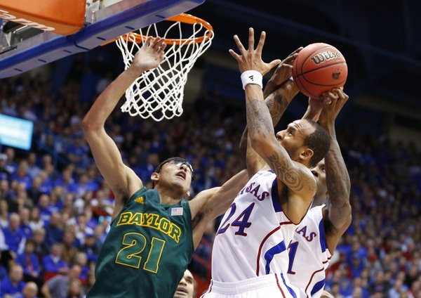 Kansas guard Travis Releford pulls a rebound away from Baylor center Isaiah Austin during the second half on Monday, Jan. 14, 2013 at Allen Fieldhouse.