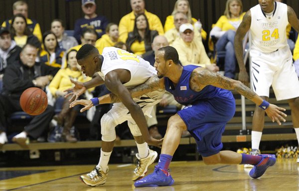Kansas guard Travis Releford (24) attempts a steal from West Virginia's Eron Harris (10) in the Jayhawks' game against the Mountaineers on Monday night in Morgantown, W.Va.