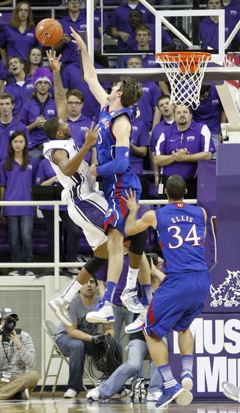 Kansas center Jeff Withey (5) blocks a shot by TCU's Connell Crossland (2) in the Jayhawks' game Wednesday at TCU in Fort Worth, Texas.
