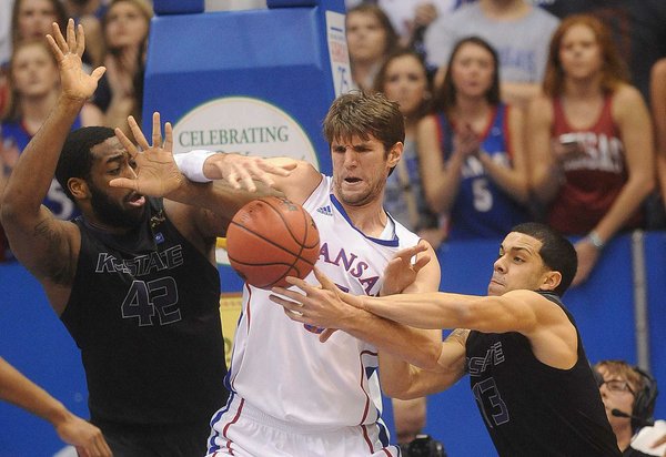 KU's center Jeff Withey (5) looks to control a rebound against KSU defenders Thomas Gipson and Angel Rodriquez (13) as KU hosted the K-State Wildcats on Monday February 11, 2013 in Allen Fieldhouse.