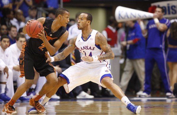 Kansas guard Travis Releford pressures Texas guard Demarcus Holland during the first half on Saturday, Feb. 16, 2013 at Allen Fieldhouse.