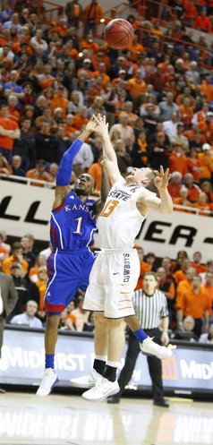 Kansas guard Naadir Tharpe puts a floater over Oklahoma State guard Phil Forte to give the Jayhawks the advantage with seconds remaining in double overtime on Wednesday, Feb. 20, 2013 at Gallagher-Iba Arena in Stillwater, Oklahoma.