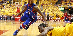 Kansas guard Elijah Johnson looks to grab a steal from Iowa State player Bubu Palo during the first half on Monday, Feb. 25, 2013 at Hilton Coliseum in Ames, Iowa.