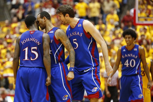 Kansas players Travis Releford and Jeff Withey (5) get up close and personal with Elijah Johnson after Johnson hit a long three in overtime against Iowa State on Monday, Feb. 25, 2013 at Hilton Coliseum in Ames, Iowa.