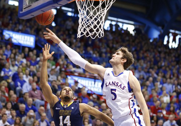 Kansas center Jeff Withey blocks a shot by West Virginia guard Gary Browne during the second half on Saturday, March 2, 2013 at Allen Fieldhouse.