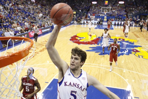 Kansas center Jeff Withey comes in for a jam against Oklahoma Jan. 26 at Allen Fieldhouse. This photo was taken using a remote camera with a wide-angle lens placed behind the glass of the backboard.
